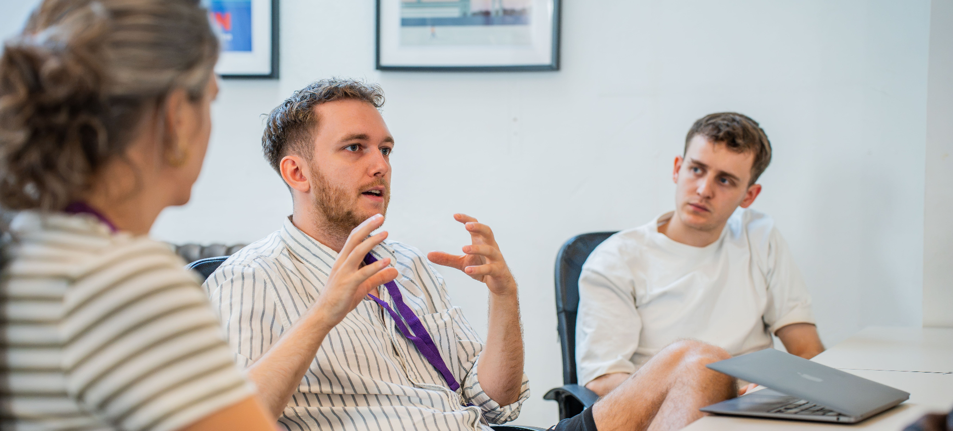A group discussion during a CommonGrnd Berlin immersion, with one person speaking animatedly while others listen